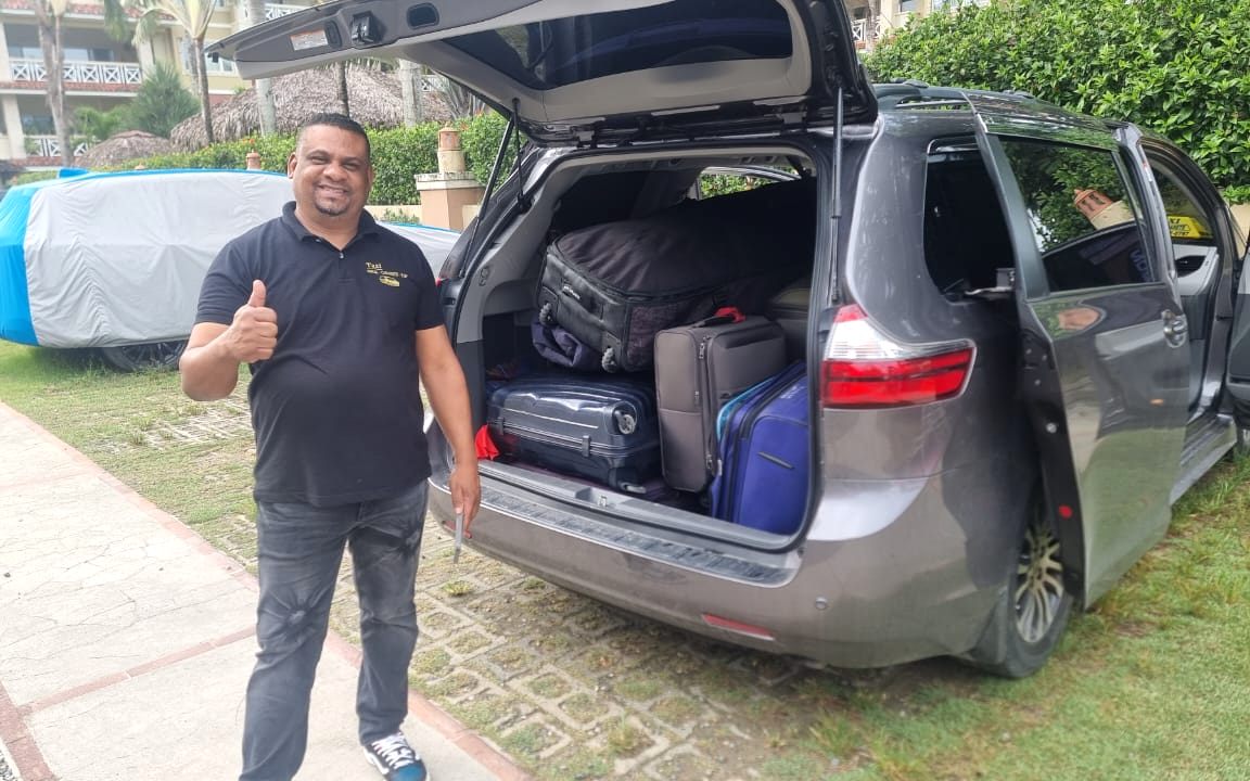 Winton beside the Toyota minivan with the trunk full of luggage
